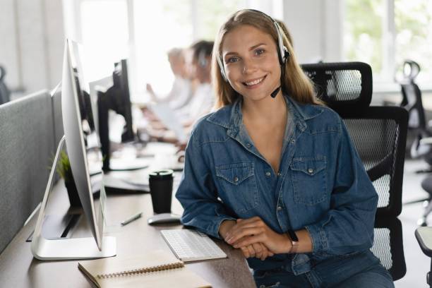 young friendly operator woman agent with headsets working in a call center